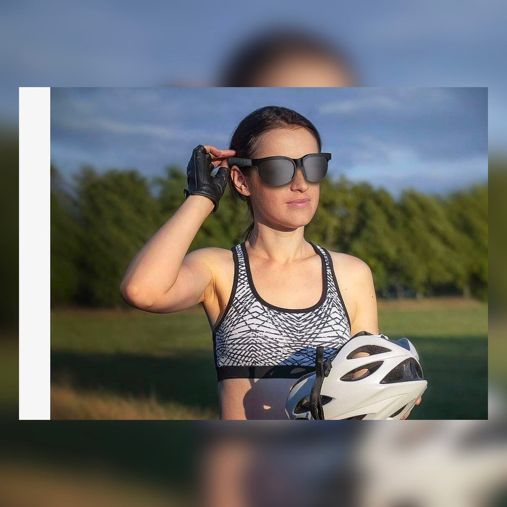 Woman wearing SonicShades audio sunglasses while cycling outdoors